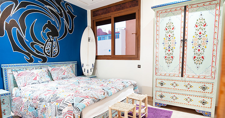 A cozy double room at Azul Guesthouse, Morocco, featuring a comfortable bed, traditional decor, and ample natural light.