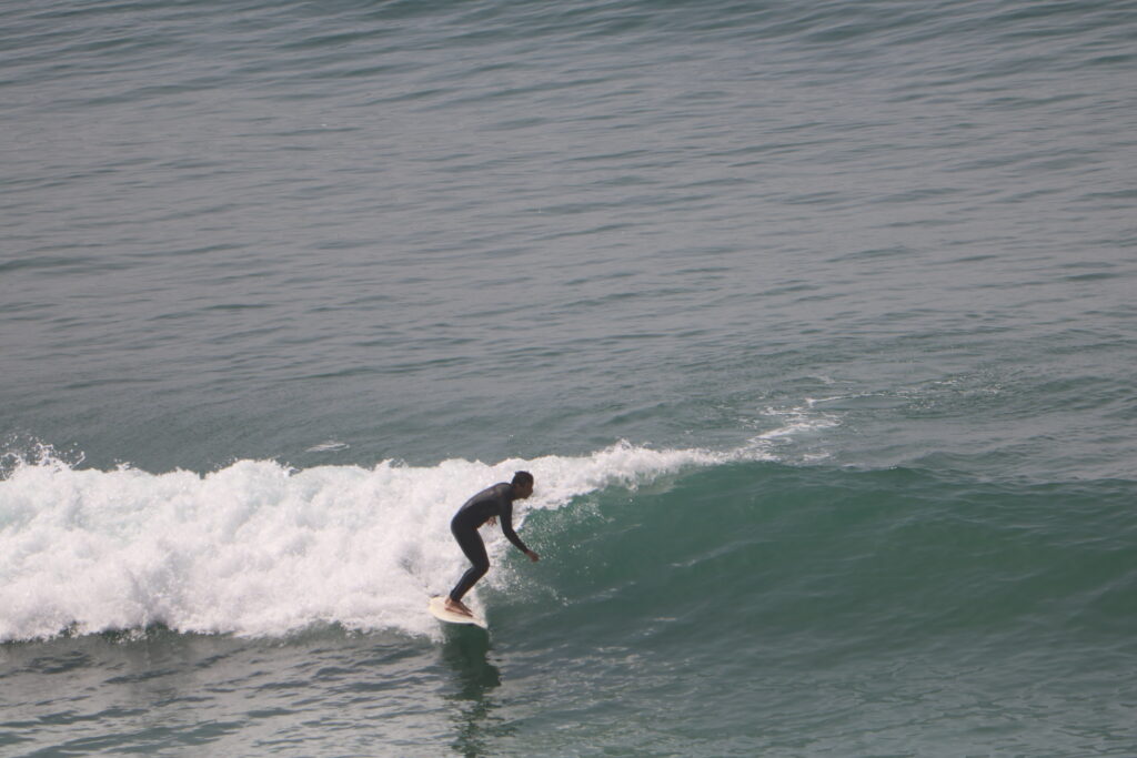 A surfer riding a wave at Km 12, Aourir, Morocco.