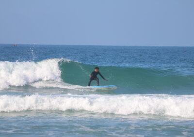 Azul Guesthouse coach surfing a perfect left wave at Crocro Beach, showcasing the pristine surf conditions of the Moroccan coastline.